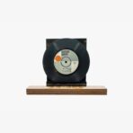 Decorative black vinyl record mounted on a wooden display base.