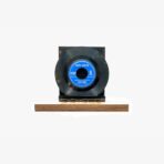 A black vinyl record mounted on a small black stand sitting on a wooden base, with a blue label in the center.