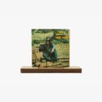 2301450027A | 3345 Records Vinyl LP cover on a wooden stand; man in a cowboy hat sits in a desert setting with bold orange text on the right.