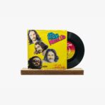 Yellow vinyl record cover with band portraits in a collage, record partly pulled out of sleeve on a wooden display stand.