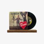 Vinyl record with a vintage cover showing a man in a suit and a red heart that reads 'Erol Büyükburç' on a wooden stand/ledge, against a plain background.